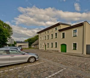 a car parked in front of a building at Willa Marina in Puck