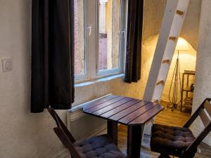 a table and two chairs in front of a window at Gîte du Vieux Lyon in Lyon +21 photos