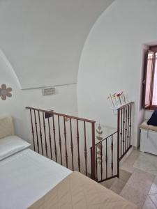 a room with a bed and a stair case at CV MiRa house in Putignano