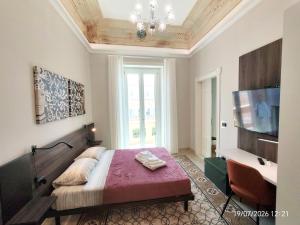 a bedroom with a large bed and a television at Dimora dei Sicani in Aragona