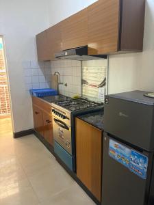 a kitchen with a stove top oven in a kitchen at City centre Apartment in Kigali