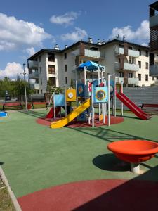 a playground with a slide and a slide at Apartament Brzeg in Augustów
