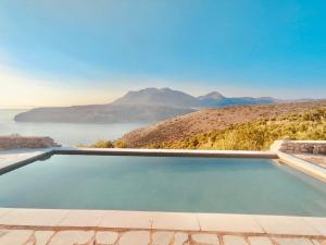 a swimming pool with a view of the water at Mani Spot Sunset View in Areopoli