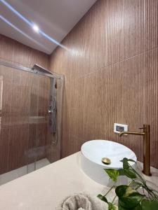 a bathroom with a sink and a shower at Sikelia home in Giardini Naxos +23 photos