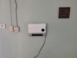 a white appliance is plugged into a wall at ARMANI MANOR UPSTAIRS UNIT 3 quaint rustic 1br in Wildwood