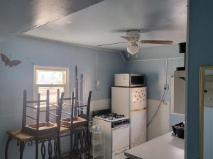 a kitchen with a white stove and a refrigerator at ARMANI MANOR UPSTAIRS UNIT 3 quaint rustic 1br in Wildwood