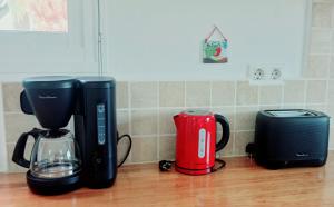 a kitchen counter with two coffeemakers and a coffee maker at Casa Yahshua in Villaverde