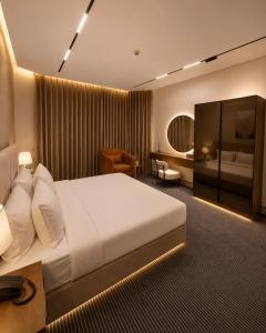 a hotel room with a large bed and a bedroom at فندق وايت ويفس White Whiffs Hotel in Ad Darb