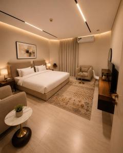 a bedroom with a bed and a couch and a chair at فندق وايت ويفس White Whiffs Hotel in Ad Darb +21 photos