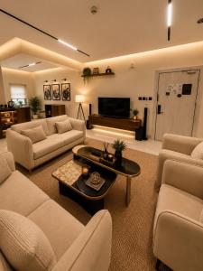 a large living room with couches and a tv at فندق وايت ويفس White Whiffs Hotel in Ad Darb