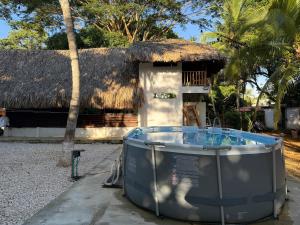 a house with a hot tub in front of a building at Cabaña Vivanco in Coveñitas