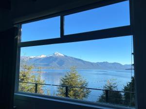 a view of a mountain from a window at Cabaña Puelo-Cochamó Tiny house in Sotomó +7 photos