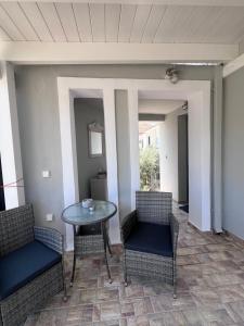 a patio with two chairs and a table and a table at Kea Harbor 1 in Korissia