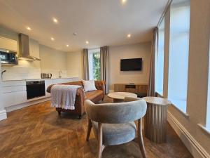 a living room with a couch and a table at Derwent Manor Apartments & Rooms in Keswick