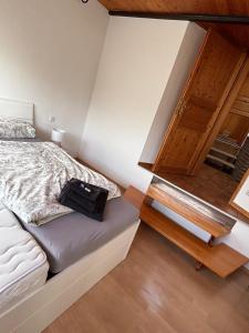 a small bedroom with a bed and a wooden door at Ferienwohnung Frieda in Bückeburg