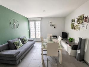 a living room with a couch and a table at LE TOURISTIC Appartements T2 et T3 in Luz-Saint-Sauveur