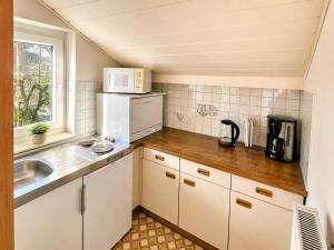 a small kitchen with a sink and a microwave at Haus Dobrosek in Tröpolach