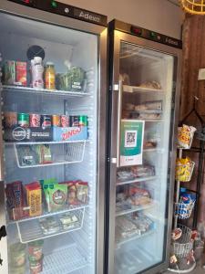 an open refrigerator filled with food and drinks at Kattugglans Gästrum 1 in Ljungby