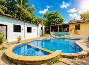 a swimming pool in the yard of a house at Royalstar Resort in Vagator