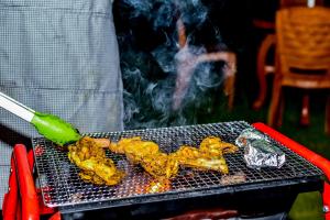 a grill with some food on top of it at MF Holiday Bungalow in Bandarawela