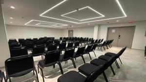 an empty room with black chairs in a building at Holiday Inn Express Belem Ananindeua by IHG in Belém