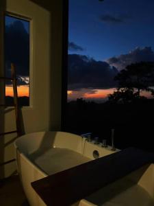 a white bath tub in a room with a window at The will glamping&camping in Ban Na Pho