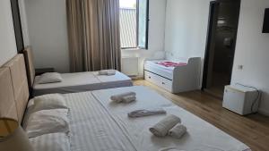 a room with two beds and towels on the floor at Belgrad Rustaveli Kobuleti in Kobuleti