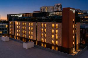 a view of a building with lights on at City Express Plus by Marriott Monterrey Nuevo Sur in Monterrey