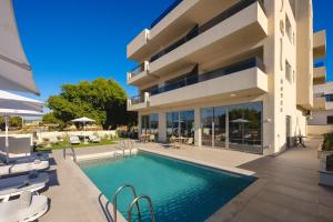 a villa with a swimming pool and patio furniture at Sal hotel Kissamos in Kissamos