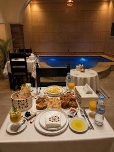 a table with plates of food on top of it at Riad Zyna in Meknès