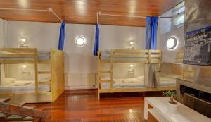 a room with three bunk beds and a fireplace at White House Lisbon Hostel in Lisbon +160 photos