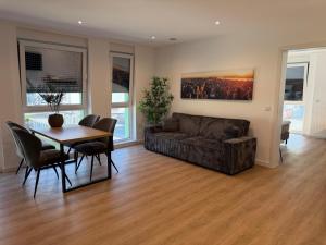 a living room with a couch and a table and chairs at Idar Apartments 11 in Idar-Oberstein +11 photos