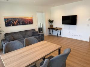 a living room with a couch and a table at Idar Apartments 11 in Idar-Oberstein