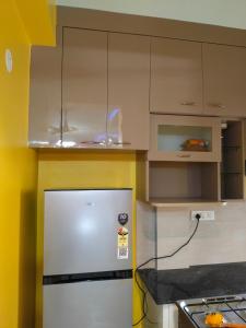 a kitchen with a stainless steel refrigerator and cabinets at North Grande in kolkata