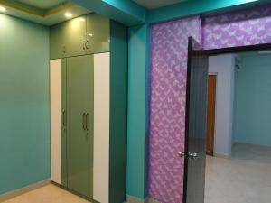 a room with colorful walls and a glass door at North Grande in kolkata