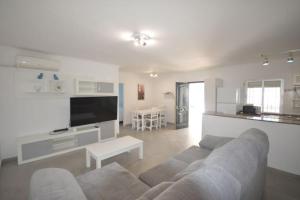 a living room with a couch and a tv at Alba Solis in Vejer de la Frontera