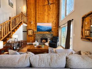 a living room with a couch and a fireplace at Slopeside Lodge at Sugar Mountain in Sugar Mountain