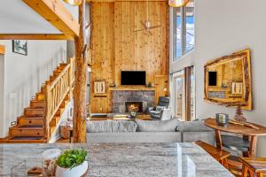 a living room with a couch and a fireplace at Slopeside Lodge at Sugar Mountain in Sugar Mountain