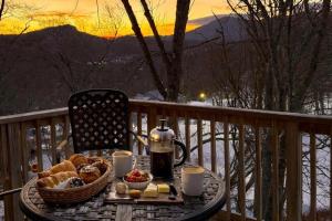 a table with a basket of food on a balcony at Slopeside Lodge at Sugar Mountain in Sugar Mountain +61 photos