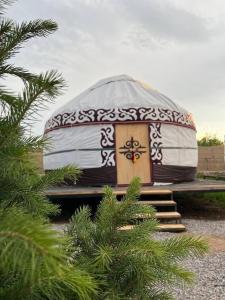 a yurt with a door and stairs in front at Yurt house in Tong