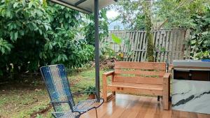 a patio with a chair and a bench and an umbrella at Little Home in General Viejo