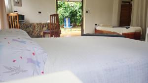 a bedroom with a bed and a living room at Little Home in General Viejo