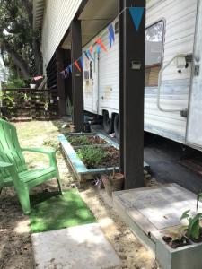 a green chair sitting in front of an rv at Tim Vales place in Tampa