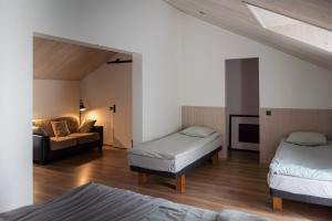 a living room with two beds and a couch at Hõbekala Guesthouse in Kalana