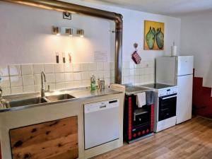 a kitchen with a sink and a stove and refrigerator at Ferienhaus Meins in Kals am Großglockner
