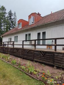 a house with a wooden deck in front of it at Valiant B&B in Otterbäcken