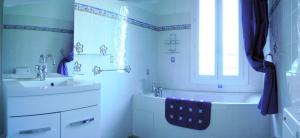 a bathroom with a sink and a tub and a sink and a bath tub at domaine de bessilles in Montagnac +23 photos