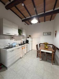 a kitchen with a table and a dining room at Aperto Tuscany apartment in Torrenieri