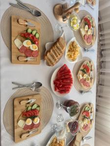 a table topped with plates of food and appetizers at Crown Inn & Spa in Karakol +24 photos