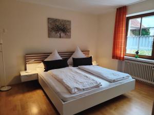 a bedroom with a bed and a window at Im Haus am Ries in Ehingen am Ries